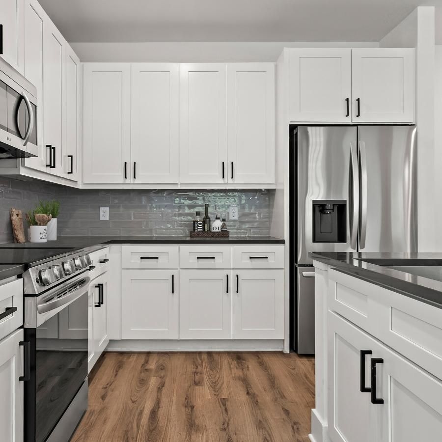 a kitchen with white cabinets